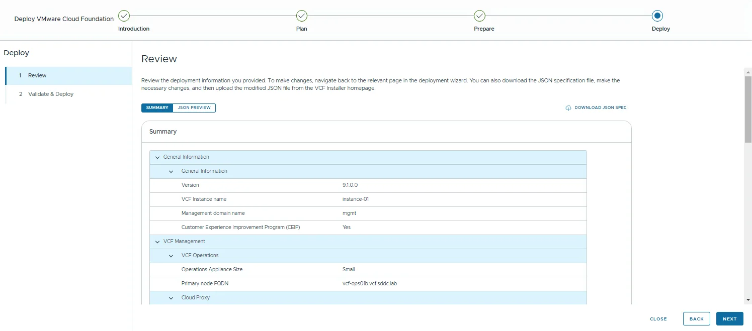 The Review step of the Deploy phase showing the deployment summary with the Download JSON Spec option.